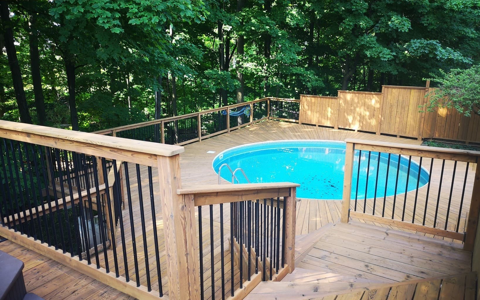 The same pool deck after washing, sanding and staining