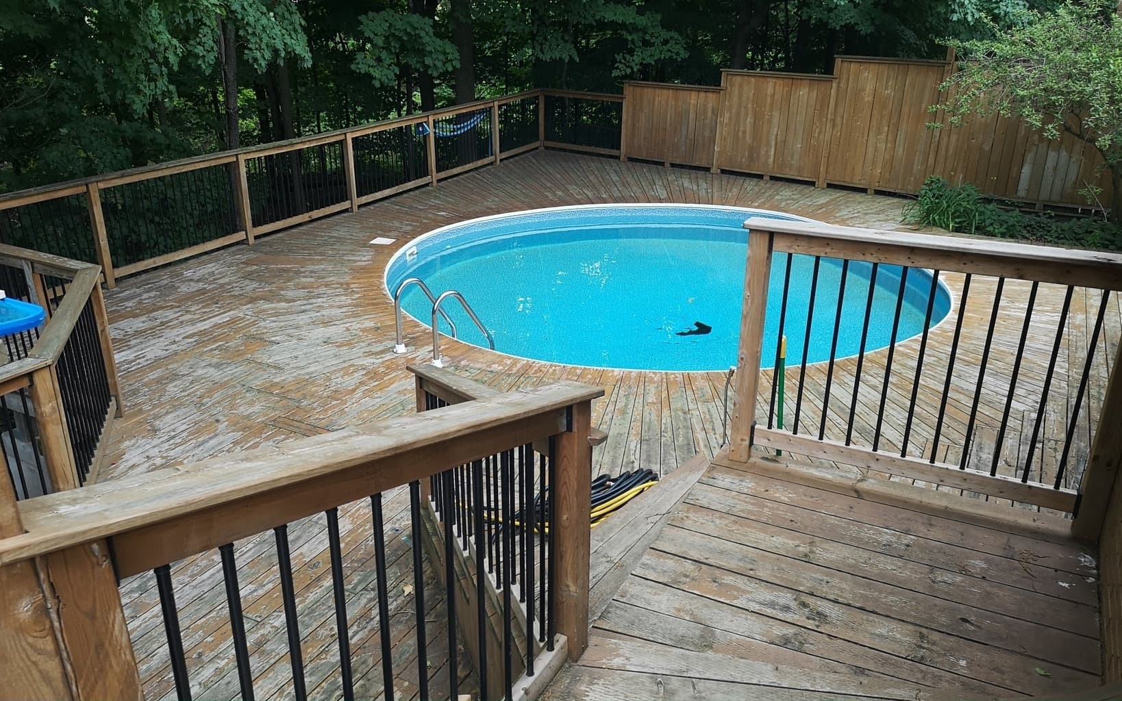 Weathered grey pool deck before restoration