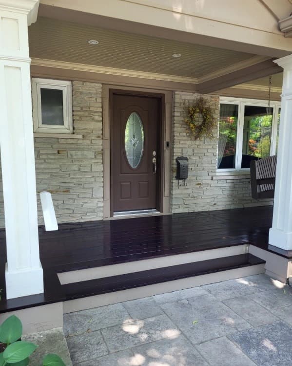 Front porch with a freshly stained dark hardwood floor